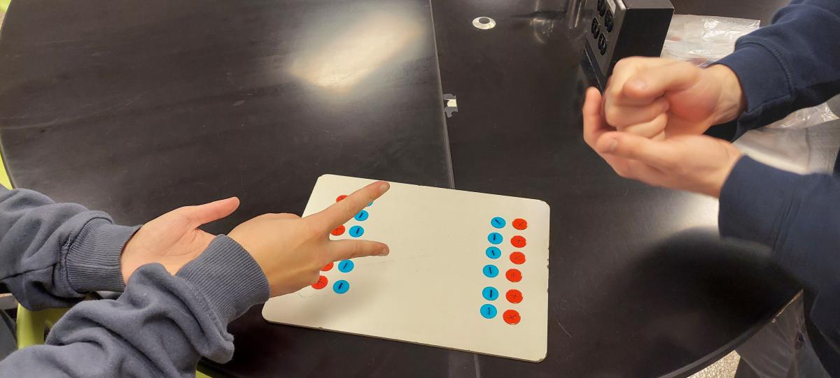 hands playing rock-paper-scissors in Ion Chip Challenge brain break