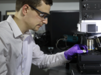 chemist using microscope