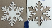 Laser cut and engraved corrugated cardboard in a snowflake shape