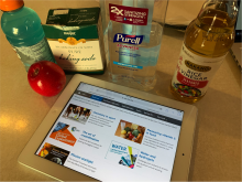 household products on kitchen counter with iPad and RSC Global Experiment website open