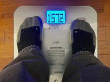 looking down at feet on a bathroom scale